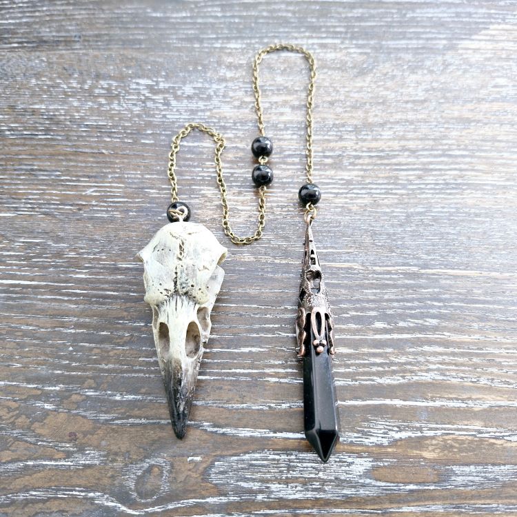 Obsidian pendulum with resin bird skull